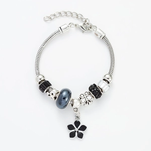 Silver snake chain bracelet with black faceted beads and a lucky clover floral pendant