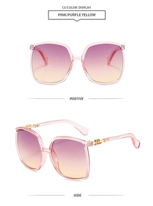 Detail view of large frame sunglasses with pink purple gradient lenses and gold hinge