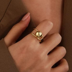 Macro shot of 18k gold plated double-layer open ring with hollow wire-wrapped ball detail