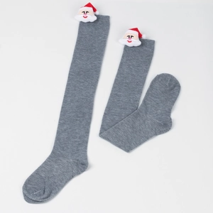 Detailed view of gray over-knee Christmas socks with 3D Santa Claus festive ornaments