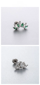 Detail of crown shaped titanium steel stud earrings featuring emerald green zircon stones