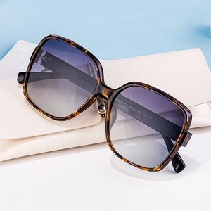 Polarized square tortoiseshell sunglasses with gradient lenses and cream folding case