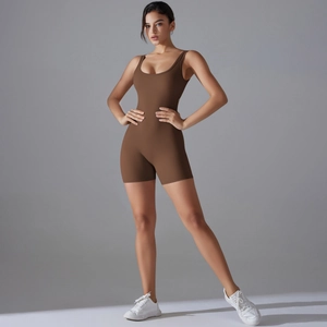 Front view of a chocolate brown one-piece yoga romper with tank top and slim-fit shorts