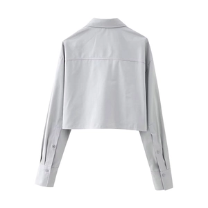 Flat lay back view showing the seams and tailored cut of the short light grey shirt