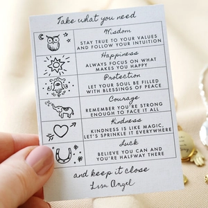 Detail of inspirational gift cards with symbolic charms and motivational quotes