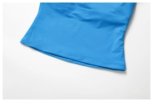 Gros plan de la couture double aiguille sur l'ourlet du débardeur de yoga bleu ciel