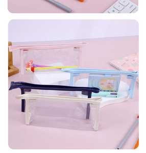 Macro view of transparent PVC pencil cases in pink, blue, navy and beige on a desk