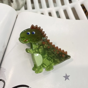 Cute green acrylic dinosaur hair claw clip for women on a white background scene