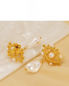 Detail of 18K gold plated evil eye earrings featuring elegant baroque white pearls