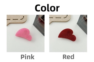 Detail view of heart-shaped hair claws in sparkling glitter pink and deep red colors