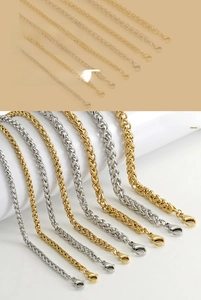 Detail of 18K gold and silver keel chains with secure lobster clasps and smooth texture