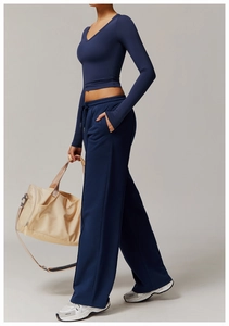 Side view detail of high-waist wide-leg navy yoga pants with drawstring and side pockets