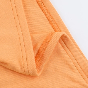 Makroaufnahme von orangefarbenem Rippstrickstoff mit Nahtdetails am rückenfreien Kleid