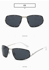 Detail of square cat-eye sunglasses with silver metal frame and rivet-studded lenses