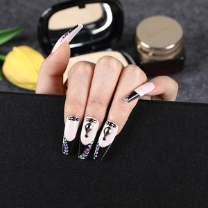 Long ballerina press-on nails with French black tips, colorful leaf patterns and rhinestones