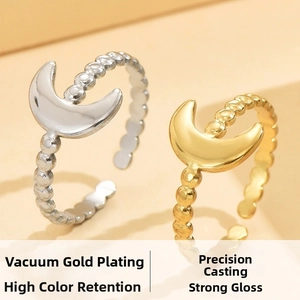 Detailed view of moon-shaped open rings with beaded texture in gold and silver plating