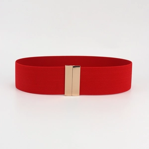 Macro detail of high-elasticity red waist belt with a polished gold rectangular buckle