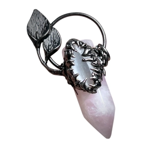 Vintage silver leaf pendant with hexagonal rose quartz crystal on white background