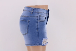 Detail of high waist light blue denim shorts featuring distressed ripped design and stitching