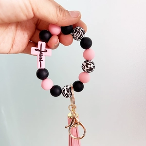 Pink and black silicone bead keychain bracelet with leopard print and a Jesus cross charm