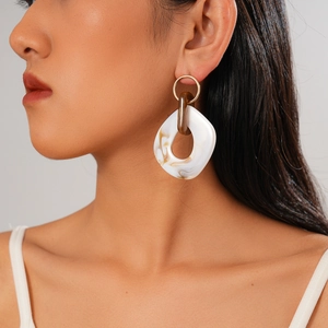 Bohemian acrylic marble earrings with gold metal ring on model in profile view