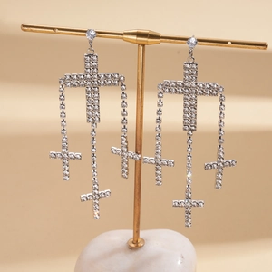 Exaggerated cross tassel earrings with silver finish and sparkling rhinestone inlay
