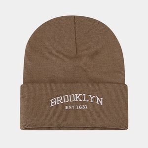 Detail of brown knit beanie featuring white embroidered BROOKLYN lettering on the cuff