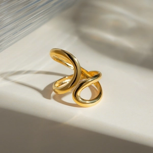 Detail of 18k gold plated open ring with sleek wave design and polished finish