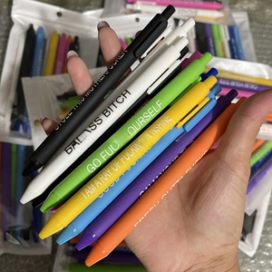 Macro shot of colorful sarcastic pens with funny quotes and click-top design