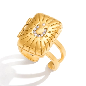 Detail of 18K gold stainless steel ring featuring fortune horseshoe and zircon inlay