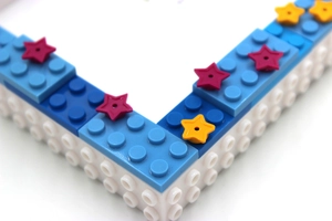Close-up of building blocks frame showing blue and white parts with star details