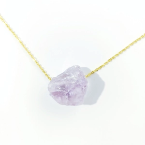 Natural purple amethyst raw stone pendant on a delicate gold chain necklace