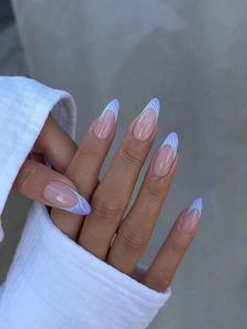 Detailed view of long blue-purple wavy French press-on nails with shiny rhinestones