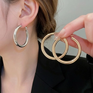 Minimalist thick polished metal hoop earrings in gold and silver finish for women