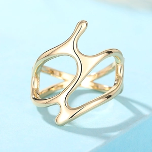 Macro view of gold hollow-out ring with abstract streamlined and irregular design
