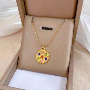 Gold titanium steel necklace featuring a round pendant with six colorful gemstones in a box