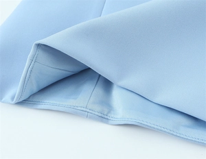 Detailed macro view of light blue knit fabric with precise stitching and fine texture