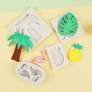 Tropical themed silicone mold with flamingo, palm leaf, and pineapple shapes for fondant
