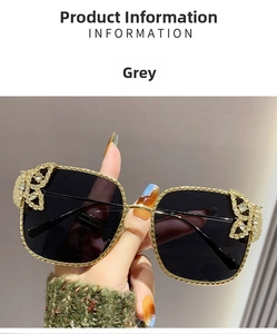 Detail of grey square sunglasses with crystal butterfly decor on gold metal frame
