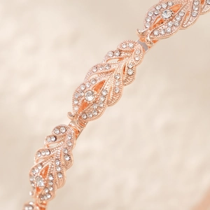Macro shot of rose gold bridal headband with sparkling rhinestones and luxury finish