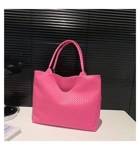 Detail shot of the woven rose pink leather texture and craftsmanship on this tote bag
