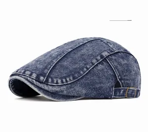 Detail of deep blue washed denim beret featuring adjustable metal buckle and retro texture
