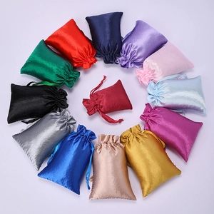 Colorful satin drawstring pouches for jewelry and gifts in a circular layout display