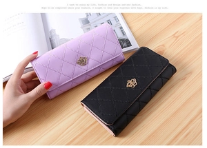 Detail of purple and black PU leather wallets with diamond pattern and crown ornament