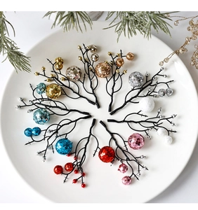 Close-up of sparkling Christmas glitter berry stems in various colors on a white plate