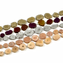 Detail of natural agate slice beads with irregular textures and metal chain links