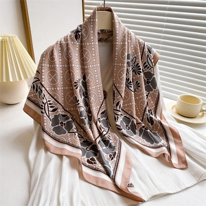Elegant 90cm square silk scarf with floral and geometric patterns on a white shirt