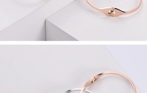 Macro detail of the hidden spring clasp and polished finish on a stainless steel bangle