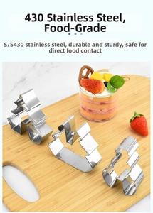 Detailed view of 3-piece stainless steel 3D Christmas cookie cutters on a wooden board