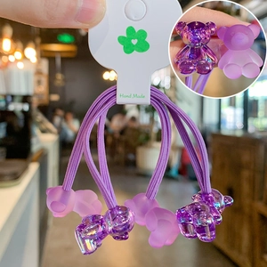 Detail of purple gummy bear hair ties set in transparent and frosted textures